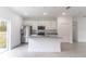Contemporary kitchen with white cabinets, an island, and modern stainless steel appliances at 13 Oak Trail Pl, Ocala, FL 34472