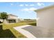 A simple backyard with a concrete patio and a well-maintained lawn at 1580 Eucalyptus Way, Davenport, FL 33837