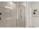Modern bathroom featuring a tiled shower with glass door, and sleek fixtures at 1580 Eucalyptus Way, Davenport, FL 33837