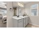 Bright bathroom with double vanity, tile floors, neutral paint, and a large mirror, creating a spa-like atmosphere at 1580 Eucalyptus Way, Davenport, FL 33837