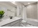 Bright bathroom featuring a modern vanity, tub/shower combo, and stylish decor at 1580 Eucalyptus Way, Davenport, FL 33837