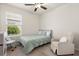 Cozy bedroom with natural light from the window, a ceiling fan, and neutral tones at 1580 Eucalyptus Way, Davenport, FL 33837