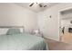 Neutrally decorated bedroom with a comfy chair, and a window at 1580 Eucalyptus Way, Davenport, FL 33837