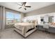 Comfortable bedroom with a ceiling fan, natural light, and a makeup vanity, creating a relaxing and inviting atmosphere at 1580 Eucalyptus Way, Davenport, FL 33837