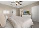 Calm bedroom with a ceiling fan, neutral colors, natural light, and a comfortable bed creating a restful environment at 1580 Eucalyptus Way, Davenport, FL 33837