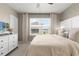 Serene bedroom featuring neutral tones, natural light, and plush bedding offering a peaceful and inviting retreat at 1580 Eucalyptus Way, Davenport, FL 33837