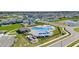 Beautiful community pool area with inviting blue water, playground, pool house, and outdoor grilling at 1580 Eucalyptus Way, Davenport, FL 33837
