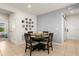Cozy dining area with tile floors, neutral paint, and an adjacent living space, perfect for entertaining guests at 1580 Eucalyptus Way, Davenport, FL 33837