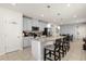 Bright kitchen with light cabinets, stainless steel appliances, granite counters and a large center island with seating at 1580 Eucalyptus Way, Davenport, FL 33837