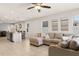 Spacious living room features tile floors, neutral paint, recessed lighting, a comfortable sectional sofa, and an open flow at 1580 Eucalyptus Way, Davenport, FL 33837