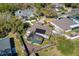Aerial view of a home featuring a screened-in pool, mature trees, and a well-manicured lawn at 1624 Malcolm Pointe Dr, Winter Garden, FL 34787