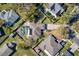 A direct aerial view showcases a home with a screened in pool, solar panels, and an extra long driveway at 1624 Malcolm Pointe Dr, Winter Garden, FL 34787