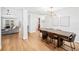 Spacious dining room featuring an oversized wood table with modern lighting at 1624 Malcolm Pointe Dr, Winter Garden, FL 34787