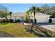 Charming single-story home with lush landscaping, attached garage, and inviting front porch at 1624 Malcolm Pointe Dr, Winter Garden, FL 34787