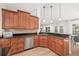Bright kitchen with stainless steel appliances, wood cabinets and granite countertops at 1624 Malcolm Pointe Dr, Winter Garden, FL 34787