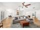 Open-concept living room flows into dining and kitchen with wood-look flooring and neutral tones at 1624 Malcolm Pointe Dr, Winter Garden, FL 34787