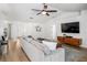 Bright living room with modern furniture, vaulted ceiling, and wood-look flooring at 1624 Malcolm Pointe Dr, Winter Garden, FL 34787