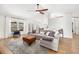 Spacious living room with large windows, comfortable seating, and view of the backyard pool at 1624 Malcolm Pointe Dr, Winter Garden, FL 34787