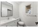 Bright bathroom features a white vanity, modern toilet, and framed mirror at 16336 Old Cheney Hwy, Orlando, FL 32833