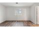 Well lit bedroom featuring wood-look flooring, clean walls and a double window at 16336 Old Cheney Hwy, Orlando, FL 32833
