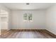 Bright bedroom featuring wood-look flooring, clean walls and two doors, one to a closet at 16336 Old Cheney Hwy, Orlando, FL 32833