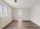 Spacious bedroom with wood-look flooring and a hall leading to other rooms at 16336 Old Cheney Hwy, Orlando, FL 32833