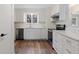 Updated kitchen with white cabinets, stone countertops, and stainless steel appliances providing a modern look at 16336 Old Cheney Hwy, Orlando, FL 32833