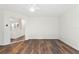 Open living room with wood-look floors and seamless access to an updated kitchen and other living spaces at 16336 Old Cheney Hwy, Orlando, FL 32833