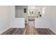 An open-concept living room featuring wood-look flooring with a view of the kitchen at 16336 Old Cheney Hwy, Orlando, FL 32833