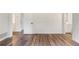 Spacious living room with wood-look flooring and doors to the bathroom and bedroom at 16336 Old Cheney Hwy, Orlando, FL 32833