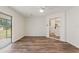 Bright living room with backyard access, wood-look flooring, and easy access to other rooms in the house at 16336 Old Cheney Hwy, Orlando, FL 32833