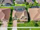 Aerial view of a home featuring a backyard screened-in pool and lush landscaping at 1802 Candlenut Cir, Apopka, FL 32712