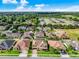 Expansive aerial view of a residential neighborhood with well-maintained homes and green spaces under a blue sky at 1802 Candlenut Cir, Apopka, FL 32712