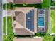Overhead shot of a house with solar panels, a screened-in pool area, and a meticulously designed roof at 1802 Candlenut Cir, Apopka, FL 32712