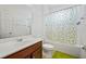 Bright bathroom featuring a single vanity, toilet, and tub with shower and stylish curtain at 1802 Candlenut Cir, Apopka, FL 32712