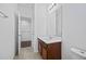 Bathroom with a vanity and mirror, with a view into a hallway, blending style and functionality at 1802 Candlenut Cir, Apopka, FL 32712