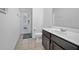 Bathroom showcasing a sink vanity with tiled floors and an exterior door at 1802 Candlenut Cir, Apopka, FL 32712