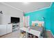 Bright bedroom featuring modern decor, gray carpet, and stylish blue accent wall at 1802 Candlenut Cir, Apopka, FL 32712