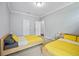 Bright bedroom featuring two twin beds with sunny yellow comforters and plenty of natural light at 1802 Candlenut Cir, Apopka, FL 32712