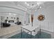 Bright dining room with modern chandelier, table and view into the cozy fireplace living room at 1802 Candlenut Cir, Apopka, FL 32712