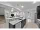 Kitchen featuring a large island with a sink and view to a living room at 1802 Candlenut Cir, Apopka, FL 32712