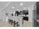 Open kitchen with stainless steel appliances, granite countertops, island seating, and dark wood cabinetry at 1802 Candlenut Cir, Apopka, FL 32712