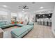 Bright, open living room featuring a modern sectional sofa and seamless flow into the kitchen area at 1802 Candlenut Cir, Apopka, FL 32712