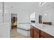 Bright bathroom with a soaking tub, double vanity sinks, and convenient access to walk-in closets at 1802 Candlenut Cir, Apopka, FL 32712