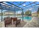 A beautiful screened-in pool, fountains, and outdoor seating create a backyard oasis at 1802 Candlenut Cir, Apopka, FL 32712