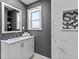 Bright bathroom with modern vanity, tiled walls, and decorative niche at 1900 E Orange Ave, Eustis, FL 32726