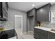 Well-lit kitchen features gray cabinets, quartz countertop and stainless steel appliances at 1900 E Orange Ave, Eustis, FL 32726