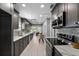 Modern kitchen with gray cabinets, stainless appliances, and bright lighting at 1900 E Orange Ave, Eustis, FL 32726
