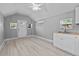Bright living area with wood floors, AC unit, and functional kitchenette with stainless steel sink at 1900 E Orange Ave, Eustis, FL 32726