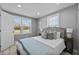 Bright bedroom features a bed, two windows, and recessed ceiling lights at 1900 E Orange Ave, Eustis, FL 32726